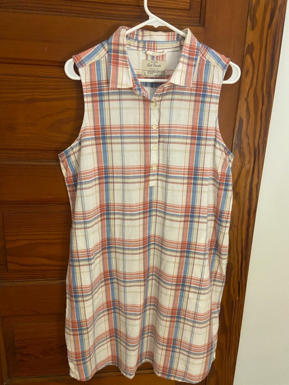Sleeveless plaid shirt dress .  Blue, pinkish red and cream .